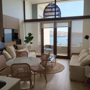 a living room with a couch and a table and chairs at HOM I Espectacular Loft con Vista al Mar en Valparaiso in Valparaíso +56 photos