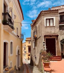 an alley in an old town with buildings at Oriente Camere in San Nicola Arcella +32 photos