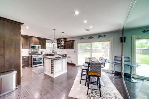 a kitchen with a counter and some chairs in it at Peace and Tranquility Home 2 Mi to Dtwn Tulsa! in Tulsa