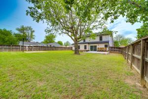 a yard with a fence and a tree at Peace and Tranquility Home 2 Mi to Dtwn Tulsa! in Tulsa