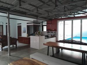 a kitchen and living room with a table and chairs at Villa Dinar Garden Lembang in Lembang