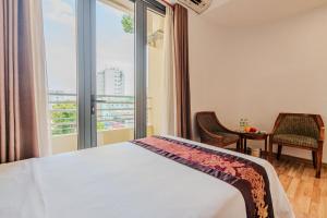 a bedroom with a bed and a large window at T78 Hotel Managed by Nha khach T78 in Ho Chi Minh City