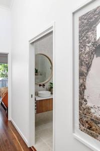 a bathroom with a sink and a mirror at 'La Palma', Sunshines Heart beside The Village in Sunshine Beach