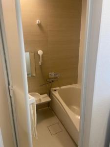 a bathroom with a tub and a toilet and a sink at Cool Treasure 7 in Kami-tatsuda +15 photos