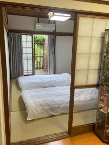 a bed in a room with a mirror at Cool Treasure 7 in Kami-tatsuda