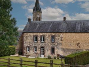 een oud bakstenen gebouw met een klokkentoren bij Maison spacieuse près du Perche avec jardin et WIFI gratuit - FR-1-497-124 in Bures