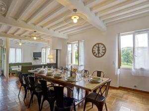 a dining room with a long table and chairs at Charmant Gîte Cocooning avec Terrasse et Animaux Acceptés - FR-1-496-306 in Belmont-de-la-Loire +10 photos