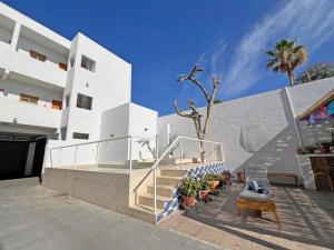 a white building with a staircase and a bench at Casa Palo Verde in Cabo San Lucas