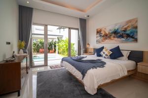 a bedroom with a bed and a dresser and a television at Villa Anastasia Aonang in Ao Nang  +51 photos