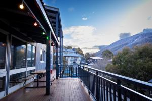 a balcony of a building with a bench on it at YHA Thredbo in Thredbo