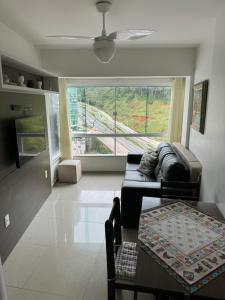 a living room with a couch and a table at Internacional Residence c linda vista Beira Mar in Balneário Camboriú