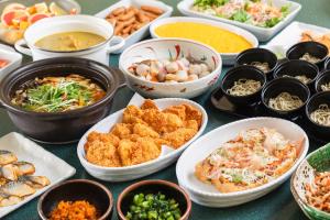 a table topped with bowls of different types of food at Hotel Sunroute Niigata in Niigata