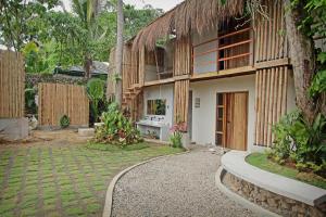 a house with a walkway in front of it at Casavia Siargao in Catangnan