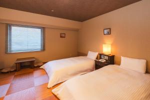 Postel nebo postele na pokoji v ubytování Hotel Sunroute Niigata