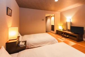 Postel nebo postele na pokoji v ubytování Hotel Sunroute Niigata