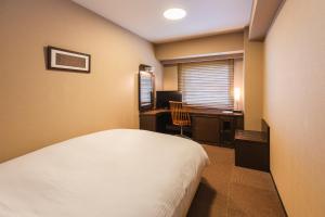 Postel nebo postele na pokoji v ubytování Hotel Sunroute Niigata