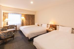 Postel nebo postele na pokoji v ubytování Hotel Sunroute Niigata