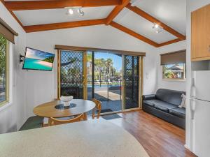 a living room with a table and a couch at Ingenia Holidays Torquay Australia in Torquay