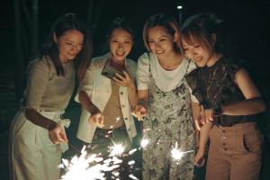 a group of women standing around a cake with sparklers at New Greenpia Tsunan in Tsunan +163 photos