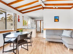 a living room with a table and a couch at Ingenia Holidays Torquay Australia in Torquay