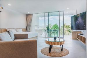 a living room with a couch and a coffee table at Replay Pool Villa in Bangrak Beach