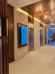 a hallway with a blue screen on a wall at Be Residences Condo - near Ayala and Cebu IT Park in Cebu City +23 photos