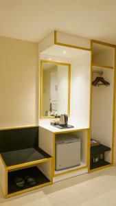 a small kitchen with a counter and a mirror at Grand Savero Hotel Bogor in Bogor