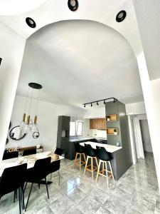 an open kitchen and dining room with a table and chairs at BeeHouse in Kalithies +13 photos