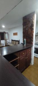 a kitchen with a counter top and a living room at Pergamino GUEST HOUSE in Pergamino +10 photos