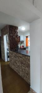 a kitchen with a stone counter top in a room at Pergamino GUEST HOUSE in Pergamino
