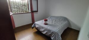 a room with a table with a bed and a window at Pergamino GUEST HOUSE in Pergamino