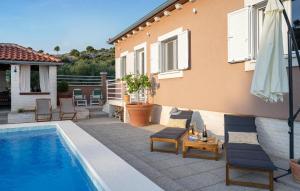a pool with chairs and a table next to a house at Terracotta in Zaboric +49 photos