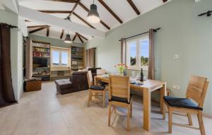 a dining room and living room with a table and chairs at Terracotta in Zaboric