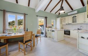 a kitchen with a table and chairs and a dining room at Terracotta in Zaboric