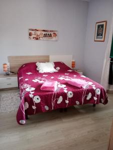 a bedroom with a bed with a red blanket at Can Pitu Ferrer in Peralada
