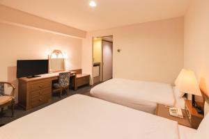 Postel nebo postele na pokoji v ubytování Hotel Sunroute Niigata