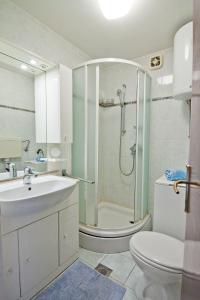 a bathroom with a shower and a toilet and a sink at Apartment Tennis in Split