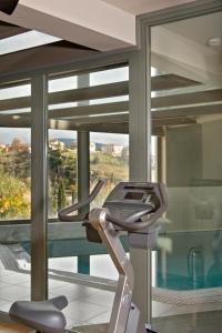 a room with a treadmill in front of a window at Aegli Arachova in Arachova