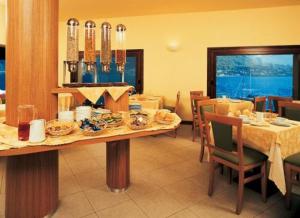 a dining room with a table with food on it at Hotel Bellavista Valmadrera in Valmadrera