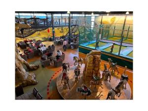 a view of a gym with people riding horses in a building at Winterswijk Modern retreat in Winterswijk-Meddo