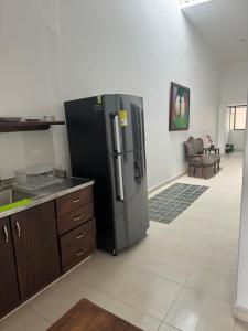 a kitchen with a black refrigerator in a room at Apartamento cerca al parque in Jardin +4 photos