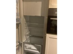 a refrigerator with empty shelves in a kitchen at Winterswijk Modern retreat in Winterswijk-Meddo