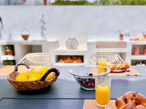 a table with a basket of fruit and a bowl of oranges at Elios Serenity House in Neo Klima