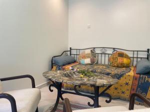a living room with a table and a couch at 7 Rayons in Avignon