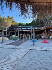 a resort on the beach with a building at Calme Beach in Vlorë