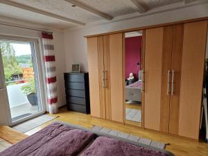 a bedroom with a bed and a large glass door at Ferienwohnung Bliestal in Sankt Wendel