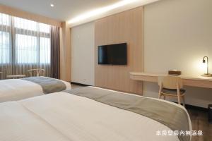 Voodi või voodid majutusasutuse Hoya Hot Springs Resort, Guanziling toas