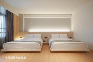 Voodi või voodid majutusasutuse Hoya Hot Springs Resort, Guanziling toas