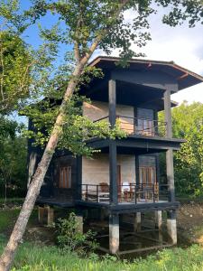 a tree house with a wrap around porch at Sigiri Vananthara in Sigiriya