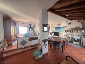 a kitchen and dining room with a table and chairs at Attico Vista Mare Trapani in Trapani